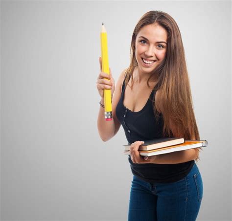 Free Photo Woman Holding A Giant Pencil And A Notebook