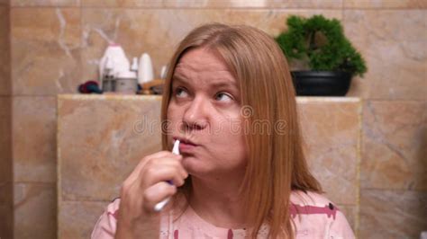 Blonde Woman Enjoys Brushing Teeth In Beige Bathroom Stock Video Video Of White Toothpaste