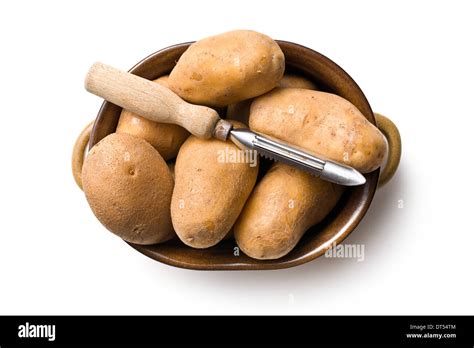 Wooden Peeler And Potatoes On White Background Stock Photo Alamy