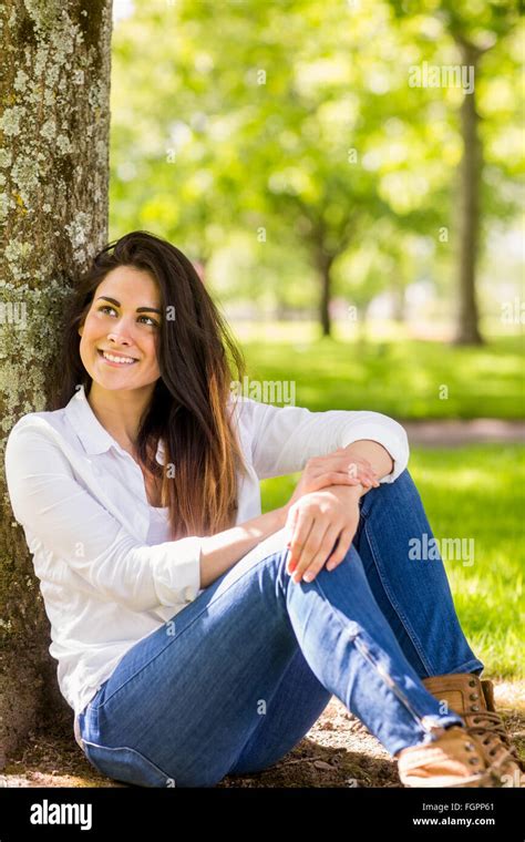 Beautiful Brunette Relaxing In The Park Stock Photo Alamy