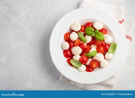 White Plate Of Classic Delicious Caprese Salad With Ripe Tomatoes