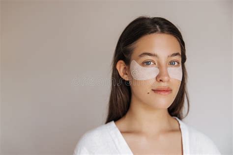 Close Up Young Caucasian Woman With White Eyes Patches Looking At