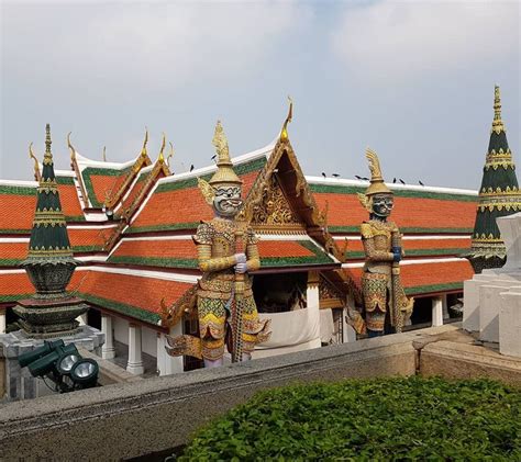 An Elaborately Decorated Building In The Middle Of A Park With Statues