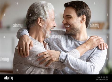 Loving Happy Mature Father And Adult Son Hug Stock Photo Alamy