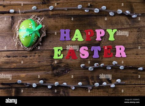 Easter Egg In Nest Pussy Willow And Sign On Color Wooden Background Stock Photo Alamy