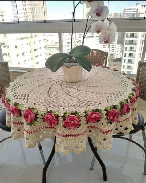 A Crocheted Table Cloth With Flowers On It