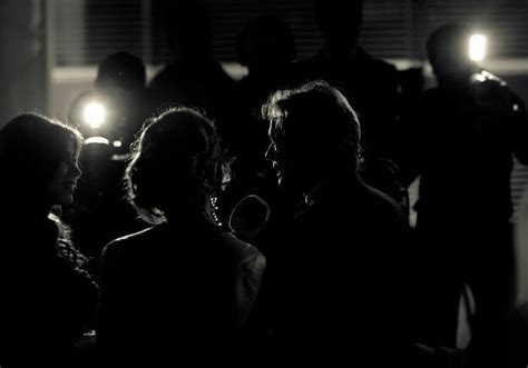 Black And White Photograph Of People Standing In The Dark