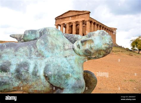 Statue Of Fallen Icarus In Bronze In Front Of The 2400 Year Old Temple