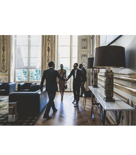 People Are Walking Through A Living Room Holding Hands