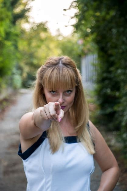 Premium Photo | Woman pointing at camera