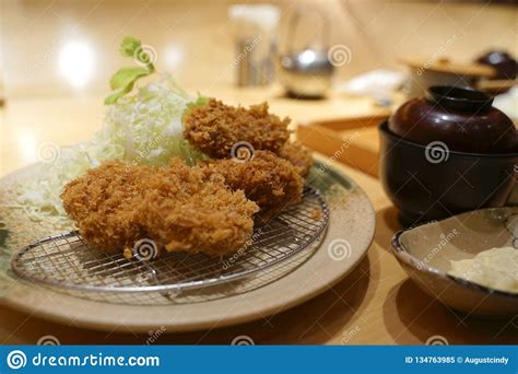 Japanese Style Batter Fried Oyster With Cabbages On Metal Mesh Stock