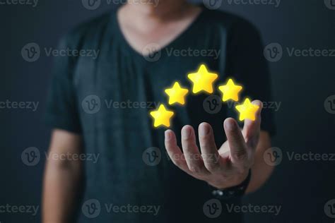 Hand Of Customer Or Client Holding The Stars To Complete Five Stars