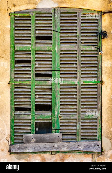 Abstract Rustic Background Of Old Broken Window Shutters On A Spanish