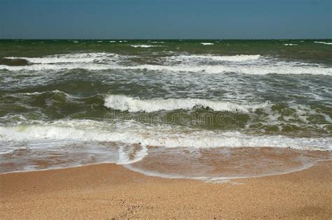 The Sea Is Stormy Sea Of Azov Happy Tanned Boy Builds Sand House