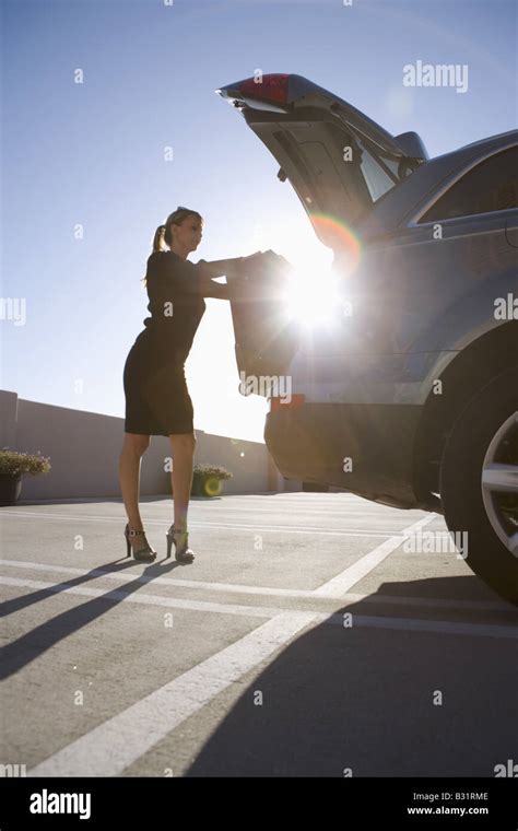 Woman Loading Luggage Into Trunk Of Suv Stock Photo Alamy