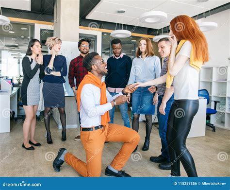 Handsome African Man Downing On Bended Knee And Proposing Marriage To