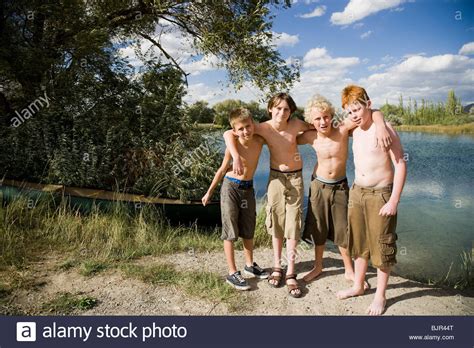 Four Boys Playing By A Lake Stock Photo Alamy