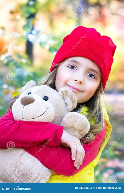 Beautiful Child Girl With Teddy Bear Portrait Outdoors Stock Photo