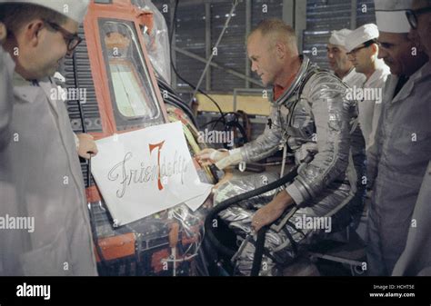 Astronaut John Glenn And Technicians Inspect Artwork That Will Be