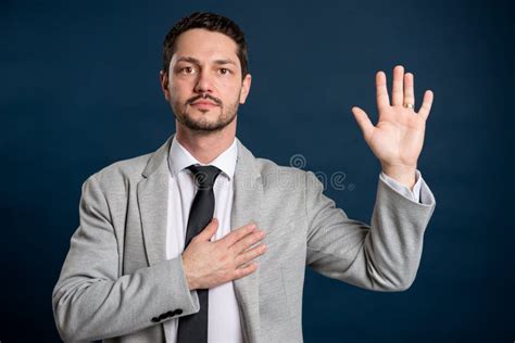 Man Making Oath Gesture With Hands Wearing Medical Surgical Mask Stock