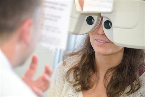 Female Patient Looking through Phoropter during Eye Exam Stock Photo - Image of exam, device ...