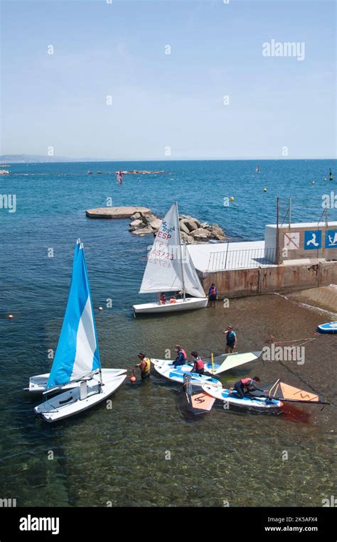 Surfers and sail boats in Barceloneta beach, Centre Municipal de Vela ...