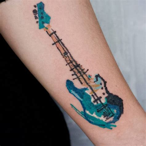 Crayon effect bass guitar tattoo located on the inner