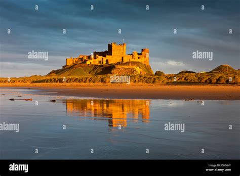 Bamburgh Castle And Its Reflection In The Last Light Of The Day