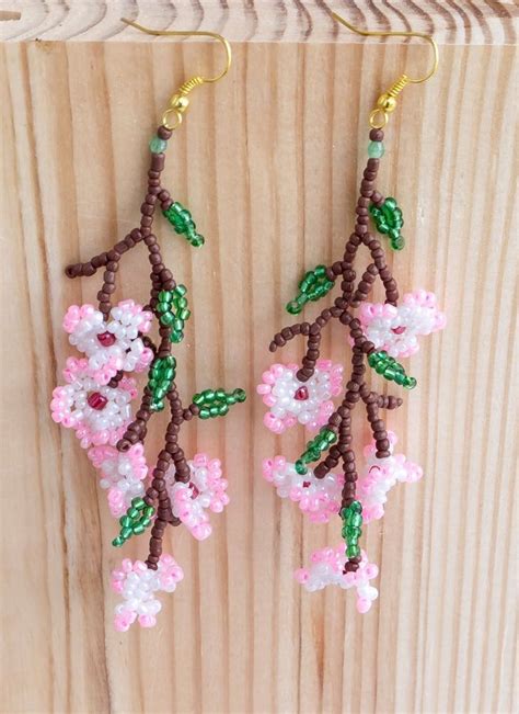 The Beaded Flowers Are Hanging From The Wood