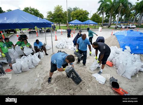 City Workers Fill Sandbags At A Drive Thru Sandbag Distribution Event For Residents Ahead Of The