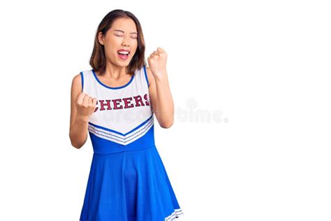 Young Beautiful Chinese Girl Wearing Cheerleader Uniform Celebrating