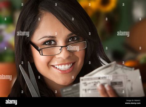 Beautiful Latina Woman At Table In Kitchen With Coupons Stock Photo Alamy