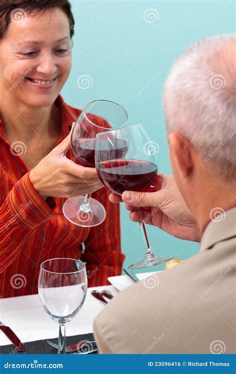 Mature Couple Toasting With Red Wine Stock Photo Image Of Bistro