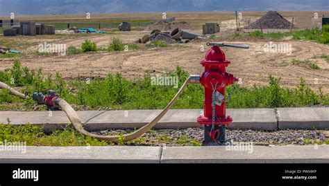 Red Fire Hydrant With Connected Hose And Wrench Stock Photo Alamy