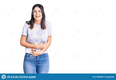 Young Beautiful Girl Wearing Casual T Shirt Smiling And Laughing Hard