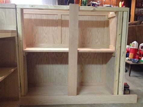 An Unfinished Kitchen Cabinet With No Doors And Shelves On The Bottom