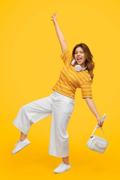 Premium Photo Cheerful Young Female Balancing On One Leg