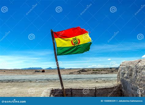 Bolivian Flag Waving In The Wind Against Blue Sky Background Stock