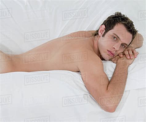 Nude Man Laying On Bed Stock Photo Dissolve