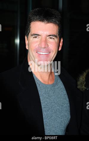 SImon Cowell pulls funny faces as arrives back at his Manchester Hotel ...