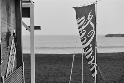 Premium Photo Flag At Beach Against Sky