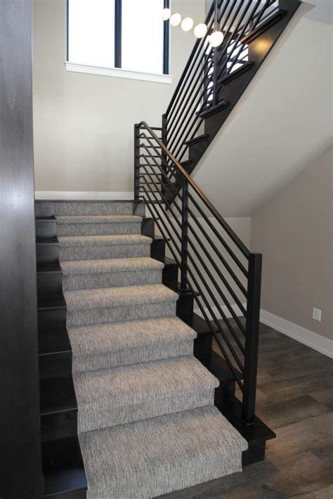 Dark Maple Hardwood Floor Staircase With Gray Carpet Patterned Stair