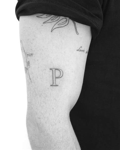 Letter P Tattoo Located On The Upper Arm