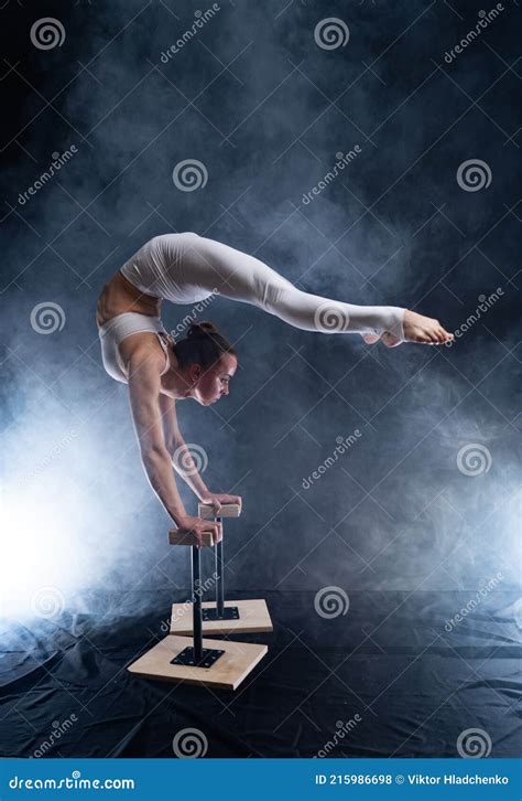 Flexible Circus Artist Female Acrobat Doing Handstand On The Back And