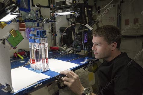 Astronaut Conducting Experiment On Iss Stock Image C0547093