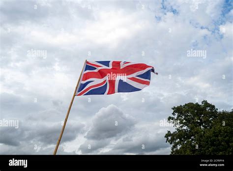 Union Jack Flag Flying Against A Cloudy Sky Stock Photo Alamy