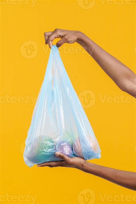 Female hands holding blue plastic trash bag with fruit 5179788 Stock ...