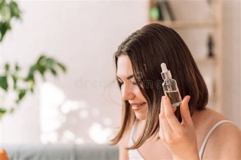 Femme Tenant Une Bouteille De Verre Avec Pipette Dans La Main Photo