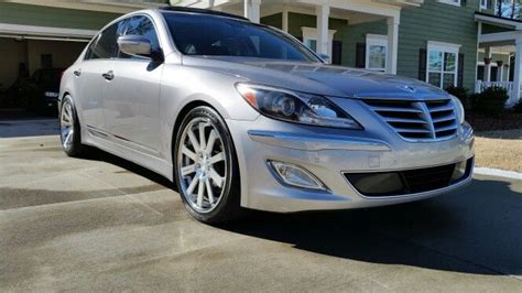 A Silver Car Parked In Front Of A House