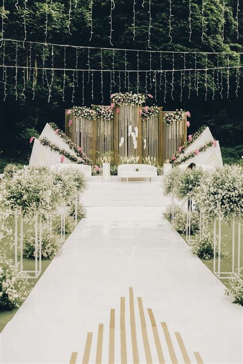 An Outdoor Ceremony Setup With Flowers And Greenery